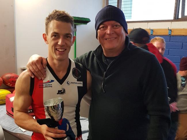 Christies Beach captain Aidan Coakley with ex-Saints player Scott Boehm and the 'sock trophy' Picture: Christies Beach president Paul Daly