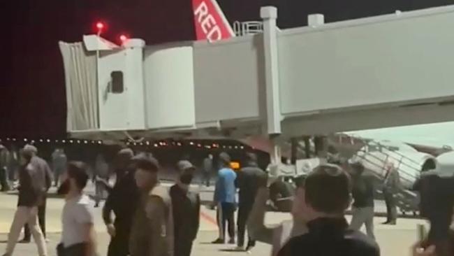 A mob scrambles across the airport tarmac at Makhachkala in the North Caucasus region of Dagestan in search of passengers on a flight from Tel Aviv after several anti-Semitic protests across the region at the weekend. Picture: Telegram