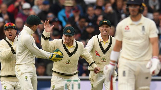 Steve Smith celebrates taking the catch to dismiss England opener Rory Burns.