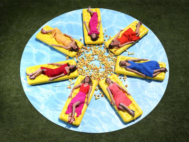 (Clockwise from top) Laura Wood, Anna McEvoy, Cassie Gardner, Grace Connolly, Georgia Connolly, Lucy McIntosh and Caris Tiivel relax in a mock bird bath at Flemington. Picture: David Caird