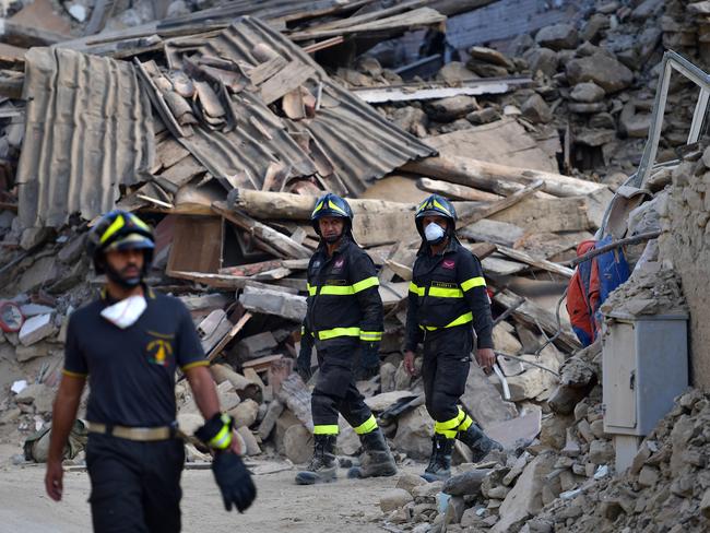 Emergency services workers check buildings destroyed the earthquake in San Lorenzo a Flaviano, Italy.