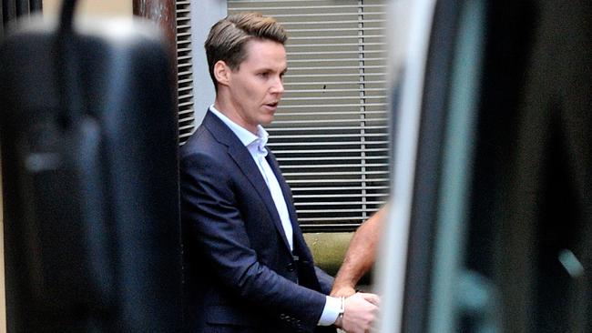 Disgraced stockbroker Oliver Curtis is escorted to a prison van at the Supreme Court. Picture: AAP