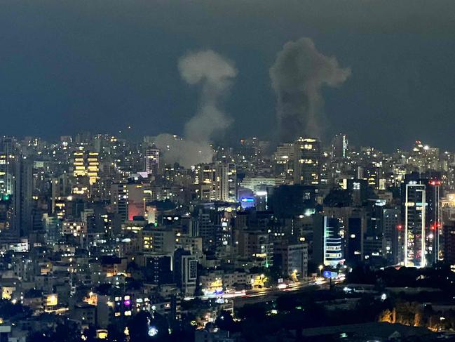 TOPSHOT - Smoke plumes rise from the site of two Israeli airstrikes on a neighbourhood in Beirut on October 10, 2024. Israel expanded operations in Lebanon nearly a year after Hezbollah began exchanging fire in support of its ally, Hamas, following the Palestinian group's deadly attack on Israel on October 7, 2023. (Photo by Mohamed ABOUELENEN / AFP)