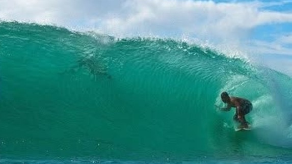 Jason Rigby riding a wave in Indonesia during a surf trip. Picture: supplied