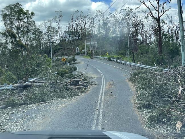 EAGLE HEIGHTS, MOUNT TAMBORINE, QUEENSLAND - NCA NewsWire Photos - 27 DECEMBER, 2023:  Fallen Power Lines and Power Poles cause major traffic hazards across multiple roads at Eagle Heights, Mt Tambourine after a massive storm swept through Christmas Night.Picture: NCA NewsWire / Scott Powick