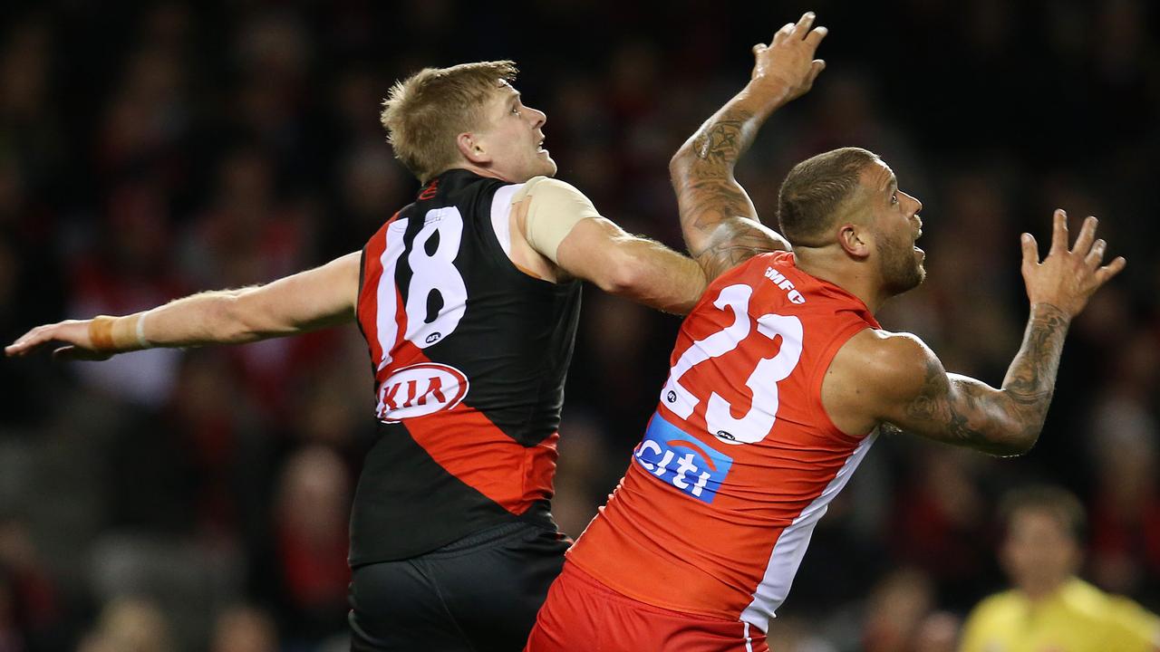 Essendon's Michael Hurley out bodies Sydney's Lance Franklin.