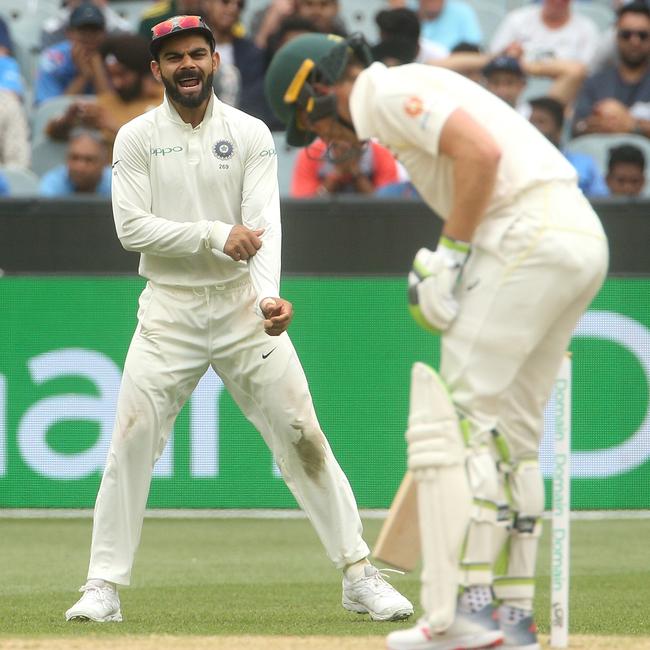 Virat Kohli of India (left) watches Tim Paine of Australia (right) batting on day four of the Boxing Day Test match between Australia and India at the MCG in 2018. Picture: AAP/HAMISH BLAIR