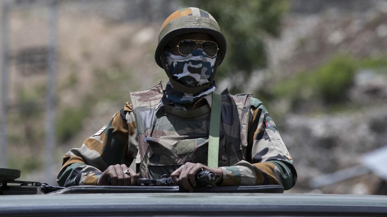 An Indian army soldier guards atop one of the vehicles as an army convoy moves on the Srinagar- Ladakh highway at Gagangeer, north-east of Srinagar, India, Wednesday, June 17, 2020. Picture: Mukhtar Khan/AP