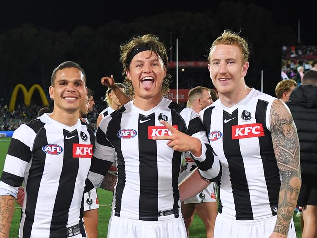 ADELAIDE, AUSTRALIA - APRIL 16:Bobby Hill ,Jack Ginnivan and Beau McCreery of the Magpies celebrates the win  afer the round five AFL match between St Kilda Saints and Collingwood Magpies at Adelaide Oval, on April 16, 2023, in Adelaide, Australia. (Photo by Mark Brake/Getty Images)