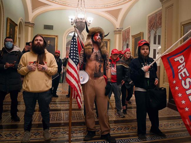 January 6 rioters. Jake Angeli, aka Yellowstone Wolf (C), was dubbed ‘Jamiroquai’ because of his elaborate head gear. Picture: Saul Loeb/AFP