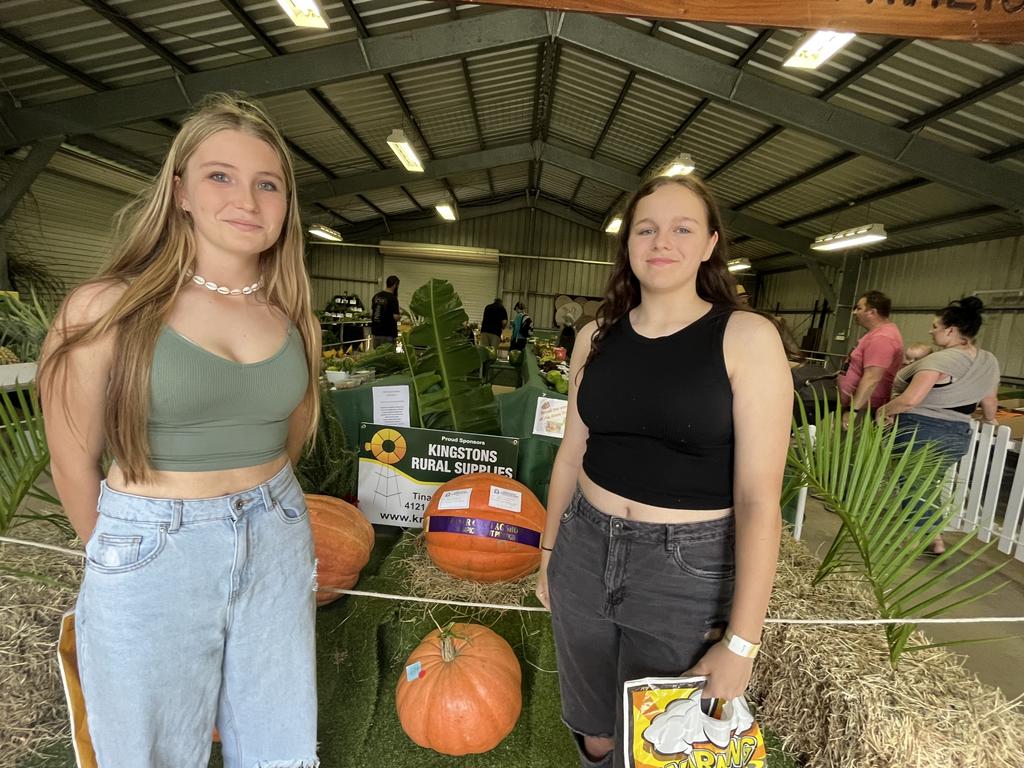 Matilda Webb and Charlee Walker taking in the agricultural display at the Fraser Coast Show, including the bumper pumpkins.