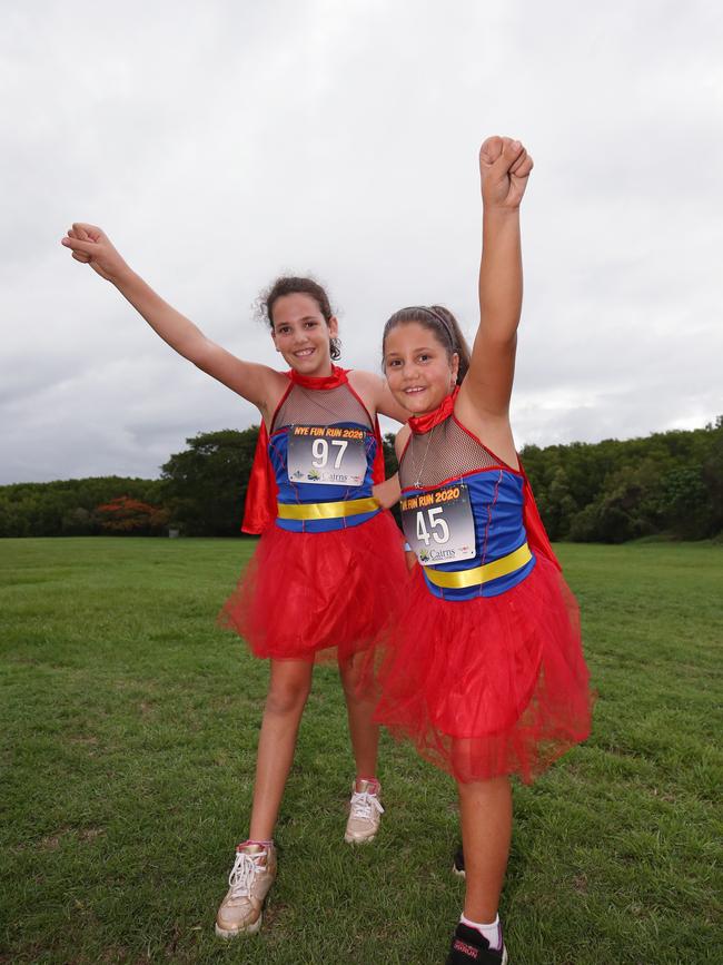 Ginny Torrisi, 10, and Rachele Musumeci, 9, at the Cairns Regional Council's New Year's Eve superhero fun run at the Cairnsesplande the Cairns Esplanade. Picture: Brendan Radke