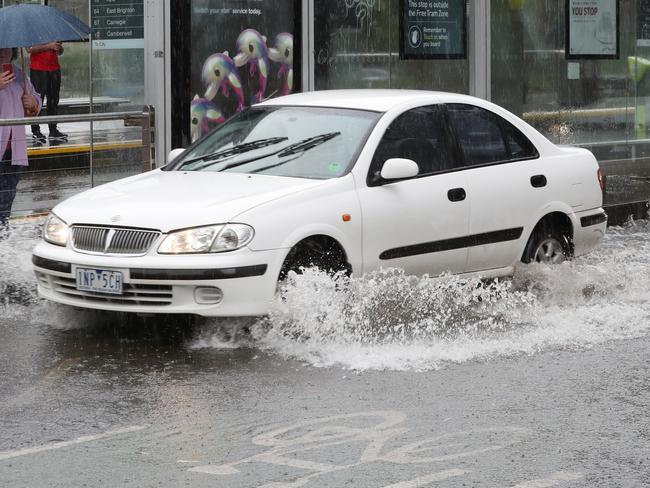 Heavy rain comes down in Swanston street. Picture: David Crosling