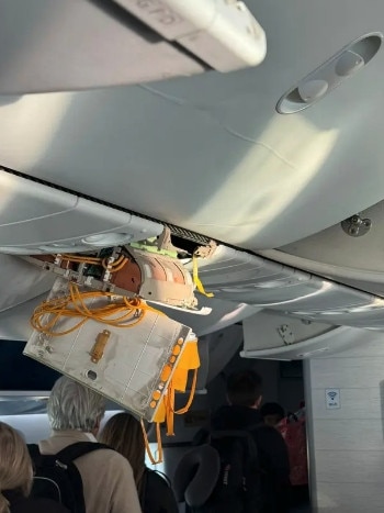 Ceiling panels torn off by the impact of the turbulence, oxygen masks dandling overhead and at least one destroyed seat.
