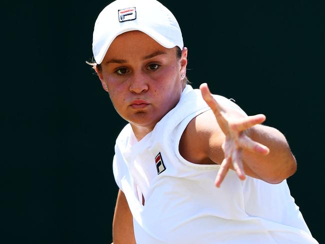 LONDON, ENGLAND - JULY 07:  Ashleigh Barty of Australia returns a shot against Daria Kasatkina of Russia duirng their Ladies' Singles third round match on day six of the Wimbledon Lawn Tennis Championships at All England Lawn Tennis and Croquet Club on July 7, 2018 in London, England.  (Photo by Clive Mason/Getty Images)