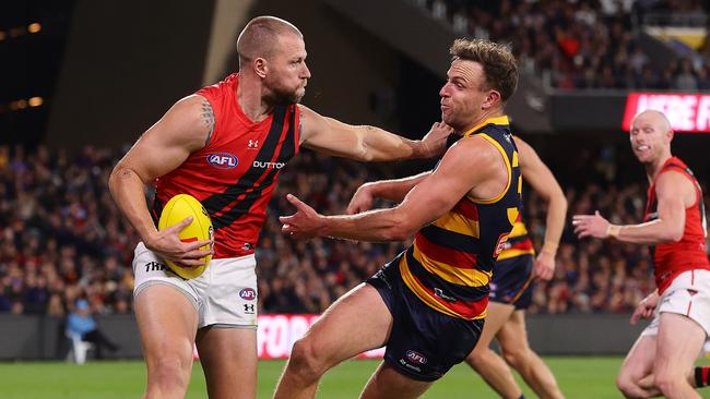 Jake Stringer of the Bombers and Brodie Smith of the Crows. Picture: Sarah Reed/AFL Photos via Getty Images