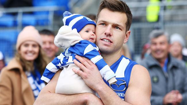 Shaun Higgins walks out with his child for his 200th match.