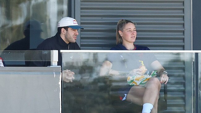 Christian Petracca and Tayla Harris watch on during the round two AFLW match between the Demons and Lions. (Photo by Morgan Hancock/AFL Photos/via Getty Images)