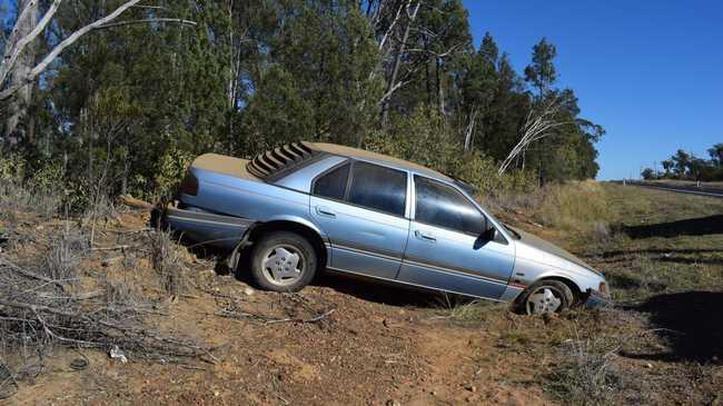 CLOSE CALL: A man and his two dogs are lucky to have escaped a single vehicle accident on the Warrego Highway this morning with no serious injuries. . Picture: Brooke Duncan