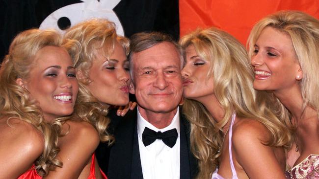 Playboy founder and editor in chief Hugh Hefner with some “friends” in 1999. (Pic: AP Laurent Rebours/AP)