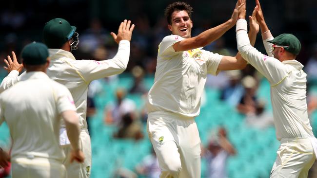 Australian players celebrate after Pat Cummins takes the wicket of England’s Mason Crane on Monday.