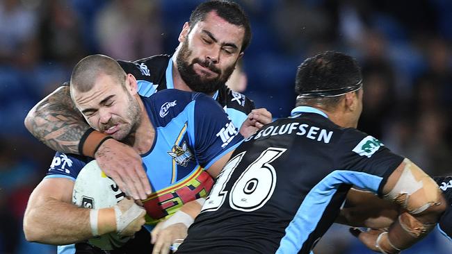 Keegan Hipgrave of the Titans is tackled by Andrew Fifita of the Sharks during the Round 8 NRL match. Photo: AAP