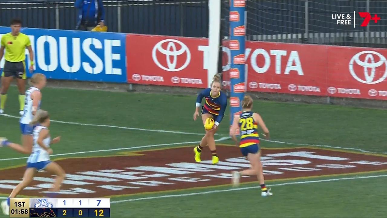 Kangaroos players were barely in frame as she picked up the ball.