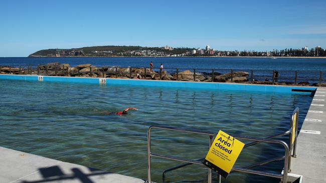 A woman swims in the closed Freshwater Beach ocean pool on April 05, 2020. Picture: Cameron Spencer/Getty Images.