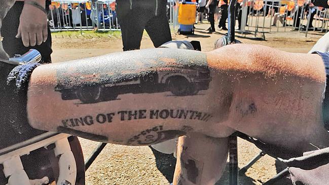 Several race fans have paid homage to the late Peter Brock with “King of the Mountain” tattoos. Picture: Matthew Dunn