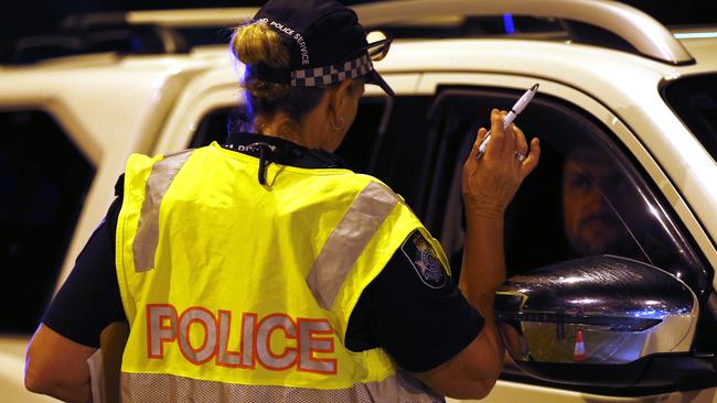 A police officer speaks to the driver of a vehicle at a roadblock near the Queensland-NSW border overhigh. Picture: Regi Varghese/AAP