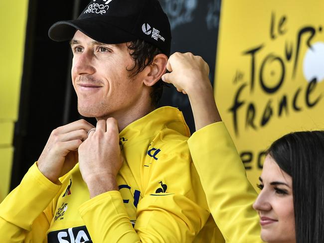 Great Britain's Geraint Thomas, wearing the overall leader's yellow jersey, celebrates on the podium after the 20th stage of the 105th edition of the Tour de France.