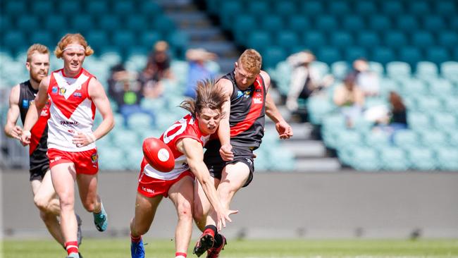 Clarence's Oliver Davis tries to smother a kick by North Launceston's Bradley Cox-Goodyer. . Picture: PATRICK GEE