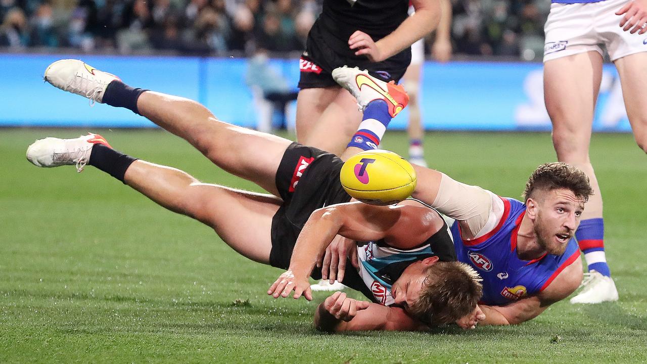 Bulldogs skipper Marcus Bontempelli tackles Ollie Wines. Picture: Sarah Reed/AFL Photos