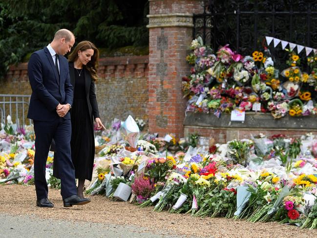 Prince William and Britain's Catherine, Princess of Wales view floral tributes outside Norwich Gate. Picture: AFP.