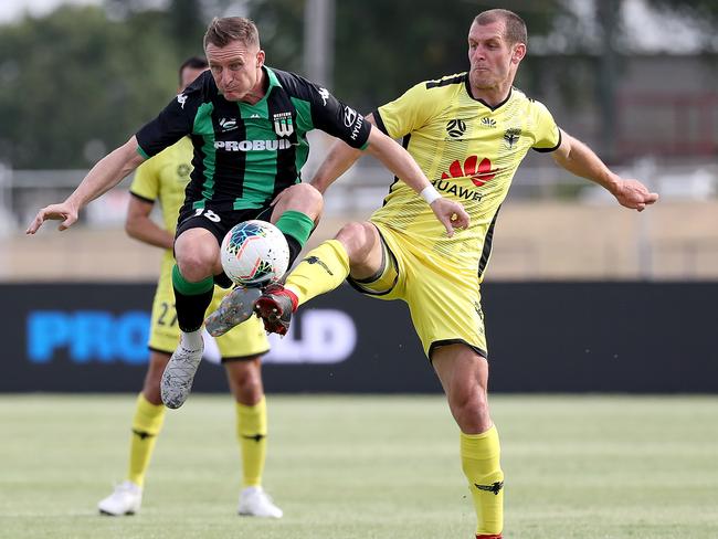 Besart Berisha (left) and Luke De Vere of Wellington Phnoenix duel for the ball at Ballarat.