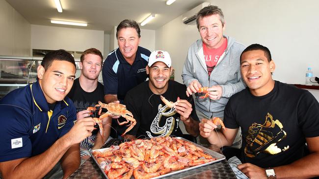 Broncos team members Antonio Winterstein, Steven Michaels David Green, Justin Hodges, Paul Green and Israel Folau with a tray of prawns. We’re not sure why. 