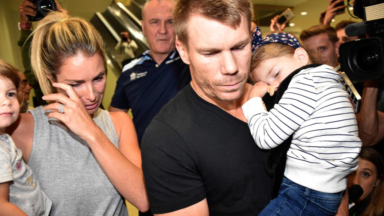 ‘I felt like a criminal’ … Candice and David Warner, with their daughters, face the media at Sydney Airport after returning from South Africa in 2018.