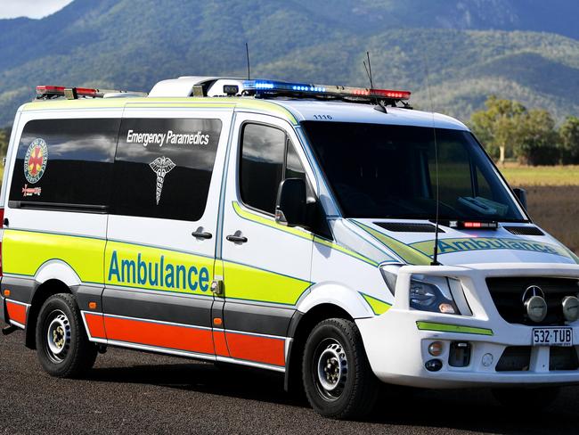 Emergency services attend a fatal car crash on the Bruce Highway, south of Townsville at Mount Surround. Garbage truck driver being looked over by paramedics.  Picture: Alix Sweeney