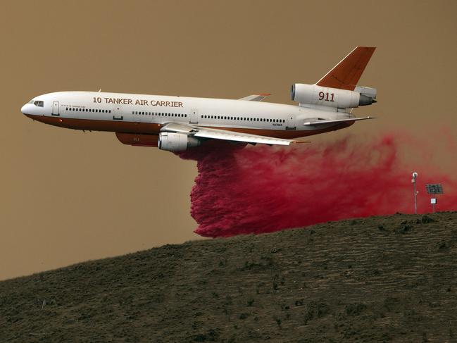 A RFS aerial bomber drops repellent near the village of Bredbo. Picture: Gary Ramage