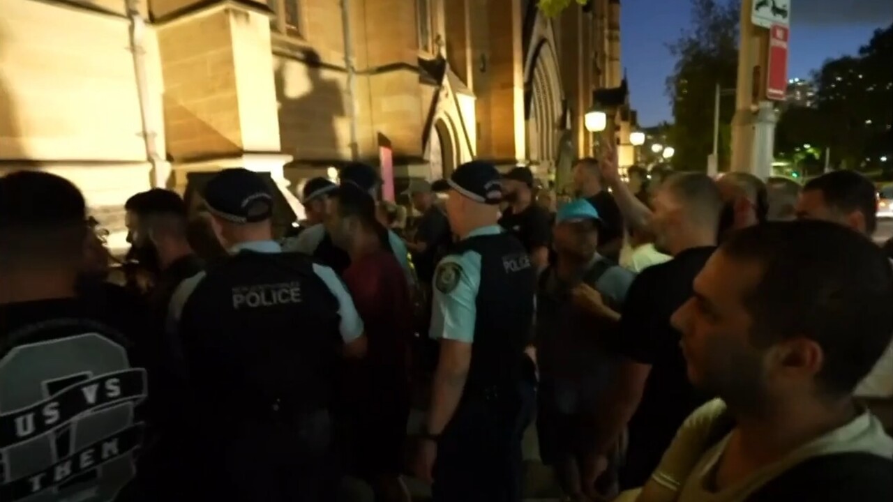 Cardinal Pell supporters clash with protesters at St Mary's cathedral funeral overnight