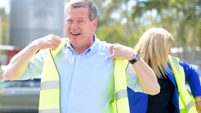 Tim Nicholls puts on PPE in Caboolture at Powercat Marine today. Picture: AAP.