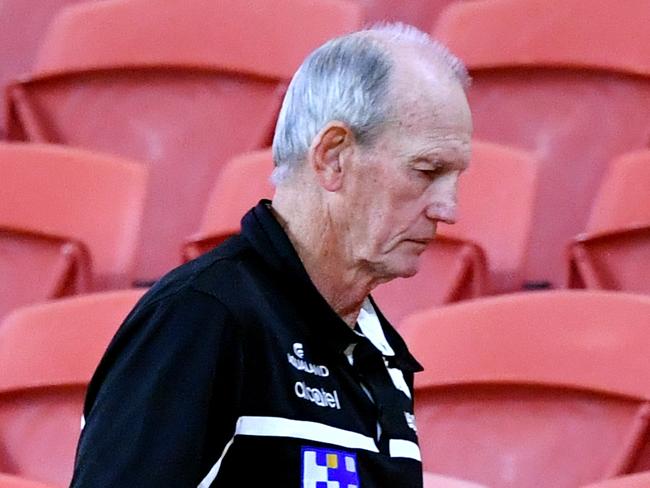 Rabbitohs coach Wayne Bennett is seen walking amongst the empty grandstand seats on full-time after losing the round two NRL match between the Brisbane Broncos and South Sydney Rabbitohs at Suncorp Stadium in Brisbane, Friday, March 20, 2020. (AAP Image/Darren England) NO ARCHIVING, EDITORIAL USE ONLY