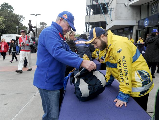 Security guards check bags as fans enter the MCG at last year’s Grand Final. Picture: Andrew Henshaw