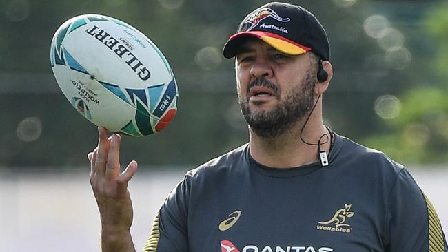 Australia's head coach Michael Cheika balances on his fingers during  a  training session in Urayasu, on September 27, 2019, during the Japan 2019 Rugby World Cup. (Photo by William WEST / AFP)