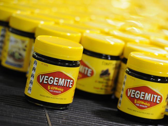 **FILE** An Oct. 24, 2013 file photo of Vegemite rolling along  the production line at the Vegemite factory in Melbourne, Thursday, Oct. 24, 2013. Bega Cheese has agreed to buy brands including Australian icon Vegemite in a deal worth $460 million, Thursday, Jan. 19, 2017. (AAP Image/Julian Smith) NO ARCHIVING