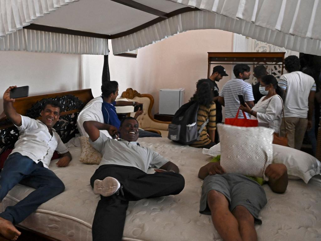 Protesters lounge on a bed inside Sri Lanka's presidential palace in Colombo. Picture: AFP