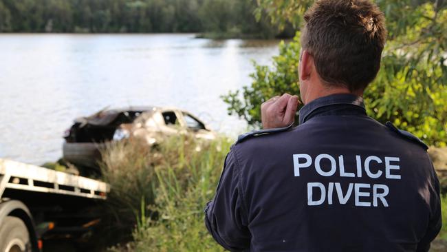 Fraud investigators recover a car related to the investigation from the Georges River at the Floyds Bay Boat Ramp, Lansvale on April 6, seizing it for forensic examination. Picutre: NSW Police