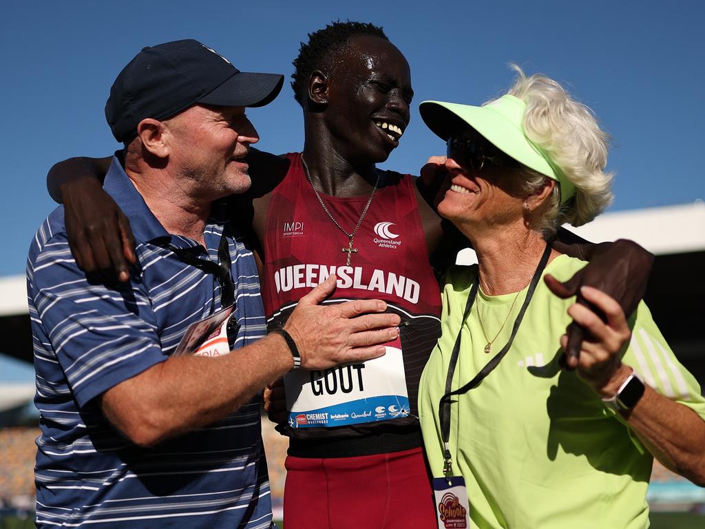 Gout Gout celebrates with manager James Templeton and coach Di Sheppard after winning the boys' U18 200m final in a new national time of 20.04sec. Picture: Cameron Spencer/Getty Images