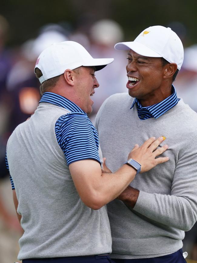 Tiger Woods embraces Justin Thomas after his matchwinning putt on the 18th hole.