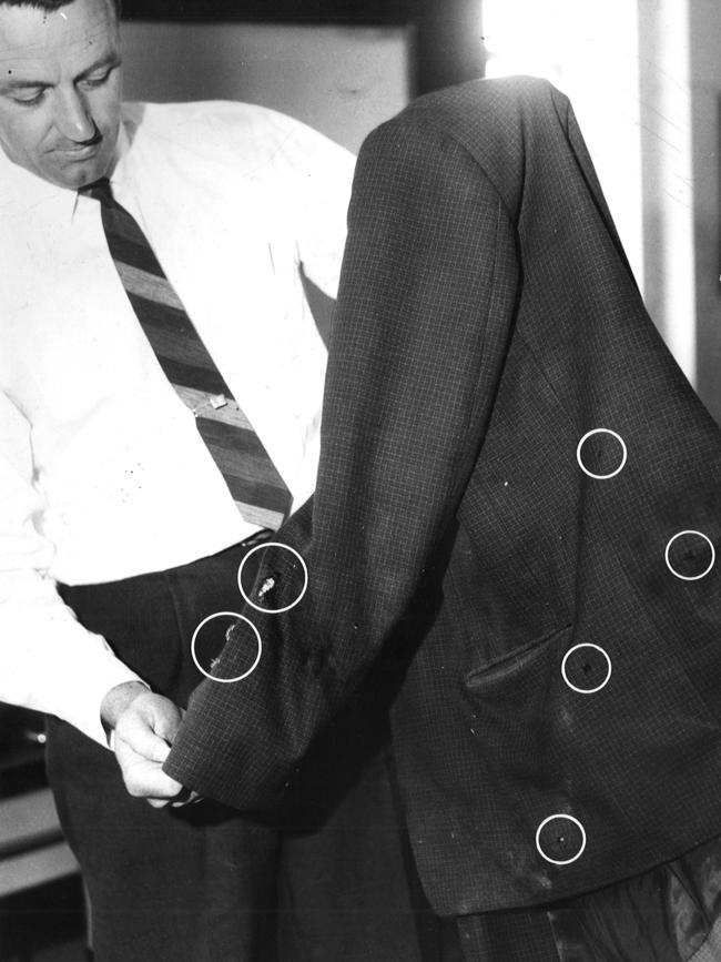 Senior Detective Theo Ferris holding Domenico Demarte’s bullet-riddled coat after he was shot in Northcote in 1963. Picture: HWT Library